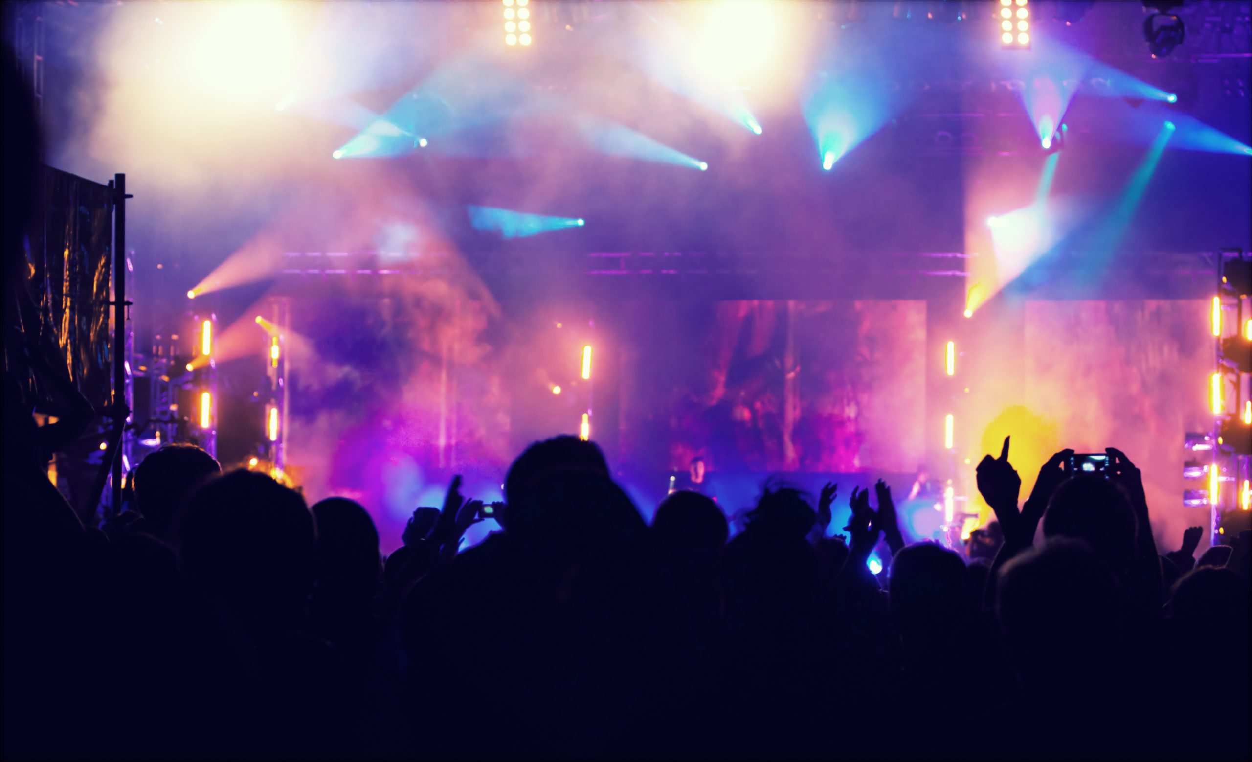 Cheering crowd in front of stage lights - retro photo
